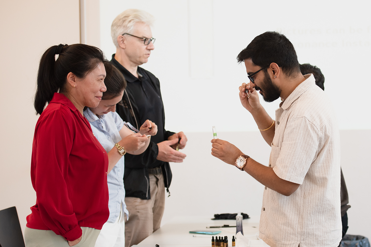 Sarthak guiding a group through smelling aromatic materials at a workshop